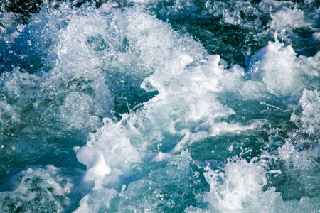 Sea waves splash with foam of crystal clear water of the Red Sea at close range