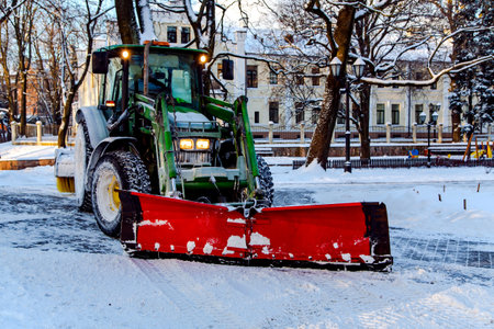LATVIA, RIGA, DECEMBER, 2018 - Snowplow truck removing snow in Riga city park, Latvia