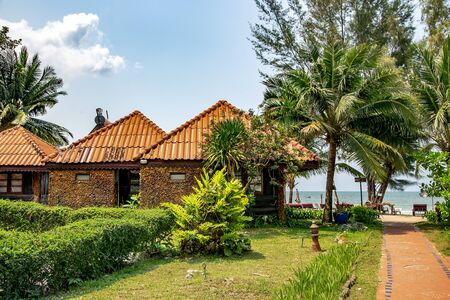 Small summer stone bungalows on the shore of the Gulf of Thailand on tropical Koh Chang island in Thailand.の写真素材
