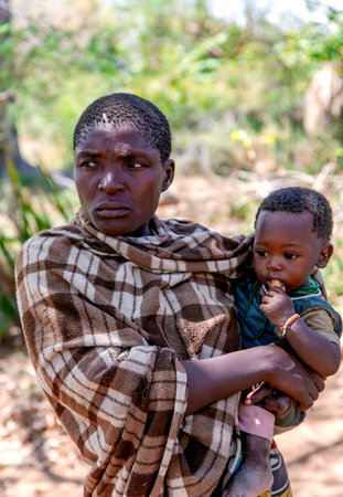 AFRICA, TANZANIA, MAY, 10, 2016 - Woman with small children of the Hadzabe tribe. Hadzabe tribe...