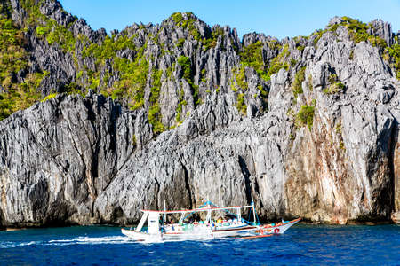 PHILIPPINES, EL NIDO, DECEMBER, 2019 - Pleasure boat with passengers in the clear waters indian ocean near El Nido Island, Philippinesのeditorial素材