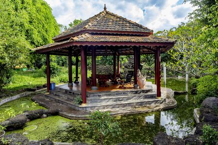 Oriental decorative arbor in a pond in a beautiful garden in Vietnamの写真素材