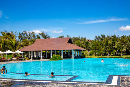 VIETNAM, MUI NE, NOVEMBER, 2013 - Relaxing around the swimming pool with cool water in Mui Ne, is mainly a midrange resort.のeditorial素材