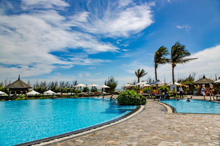 VIETNAM, MUI NE, NOVEMBER, 2013 - Relaxing around the swimming pool with cool water in Mui Ne, is mainly a midrange resort.のeditorial素材