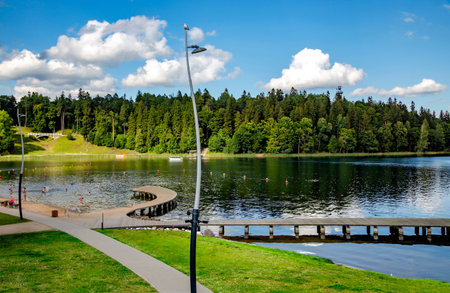 LATVIA, ALUKSNE, AUGUST, 2020 - Wooden pier next to the city beach on a beautiful large lake in Aluksneのeditorial素材