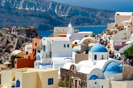 GREECE, SANTORINI, SEPTEMBER, 2012 - Fira town with white houses and blue roofs against the backdrop...