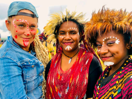 INDONESIA, PAPUA NEW GUINEA, WAMENA, IRIAN JAYA, 20 AUGUST 2018: Young girls of a papuan tribe in a beautiful crown from bird feathers on Baliem Valley festival in Wamena, Papua New Guinea.のeditorial素材