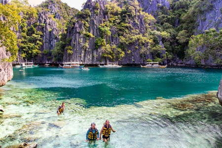 PHILIPPINES, PALAWAN, CORON ISLAND, DECEMBER, 2019 - Pleasure boats with tourists sailed to a beautiful bay on Barracuda lake, Coron, Palawanのeditorial素材