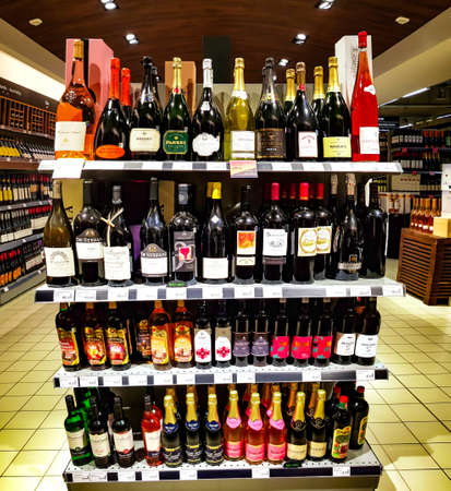 Latvia, Riga, February, 13, 2021 - Shelves with various of wines from various vineyards in the shopping mall in Riga, Latviaのeditorial素材