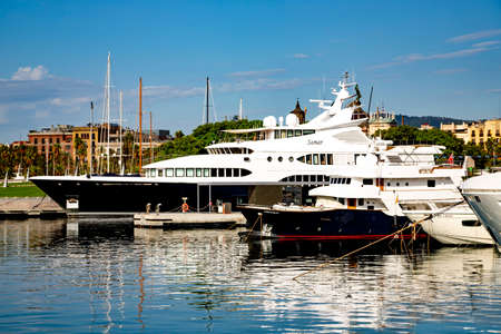 SPAIN, BARCELONA, SEPTEMBER, 2020: Luxury yachts in Port Vell (Old Harbour) on sunset. Port Vell and Rambla de Mar - one of main attractions in Barcelona.のeditorial素材