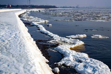 Ice covered rocky coast of the Baltic Sea on wintertime in Latvia.White snow, ice covers the land on seaside.の写真素材