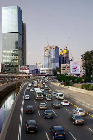 ISRAEL, TEL AVIV, MARCH, 20, 2016 - Top view of multi-lane freeway with city traffic against the background of multi-storey office buildings in the streets of Tel Aviv, Israelのeditorial素材