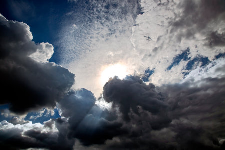 Beautiful blue sky with cumulus clouds cumulonimbus, bottom view, full frame.の写真素材
