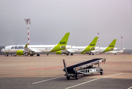 LATVIA, RIGA, MARCH, 2021 - Many Aircraft of Airbaltic parked at Riga International airport....