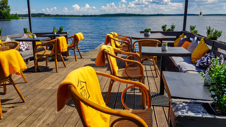 LATVIA, RIGA, JULY, 2021 - An open veranda of a summer cafe on the shore Kisezers lake - one of the...