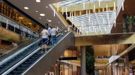 LATVIA, RIGA, JULY, 2021 - Visitors riding the escalator in Alfa shopping mall on Brivibas street at Riga, Latvia.のeditorial素材