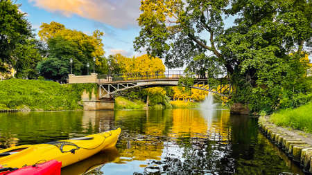 Two kayaks floats along the city canal on sunset in downtown of Riga, the capital of Latvia.の写真素材