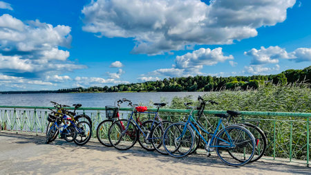 Pier with many bicycles near the shore Kisezers lake in Mezaparks, Riga. Latvia. Concept of sport, biking and active leisure.の写真素材