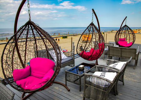 LATVIA, RIGA, AUGUST, 2021 - Relaxation area with sun loungers egg chair on the open veranda of the...