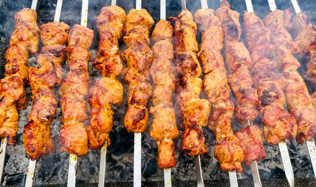 Delicious fresh grilled chicken shish kebab, usually marinated, cooked on skewers over the coals.