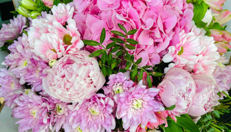 Beautiful composition in a bouquet of with pink hydrangeas and peonies. Floral shop concept. Handsome fresh bouquet. Flowers delivery.の写真素材