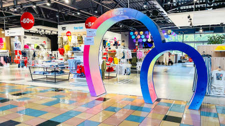 Latvia, Riga, August, 2021 - Children`s clothing section with striking color architectural details in commercial SKY & MORE shopping mall in Riga, Latviaのeditorial素材