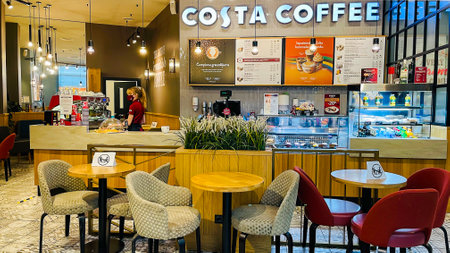 LATVIA, RIGA, AUGUST, 2021 - Cozy modern COSTA COFFEE cafe interior in Riga, capital of Latvia. Modern european small cozy cafe.のeditorial素材