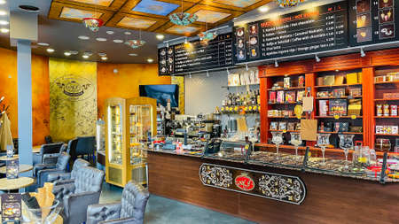 Latvia, Riga, August, 2021 - Cozy modern Chocolate House cafe interior in Riga, capital of Latvia. Modern european small cozy cafeのeditorial素材