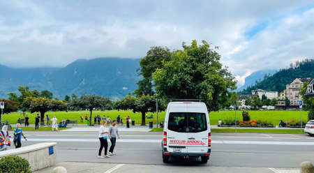 SWITZERLAND, INTERLAKEN, AUGUST 2021 - HÃ¶heweg the main street with pedestrians in Interlaken, Bernese Oberland, Switzerlandのeditorial素材