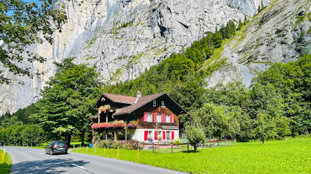 SWITZERLAND, INTERLAKEN, AUGUST 2021 - Ancient wooden house in the mountains overgrown with forest of Bernese Oberland, Switzerland. Typical wooden architecture of Switzerland.のeditorial素材
