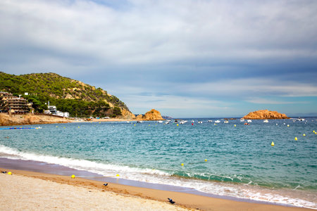Beautiful Badia bay with rocks on Mediterranean coast in Tossa de Mar located in popular Costa...