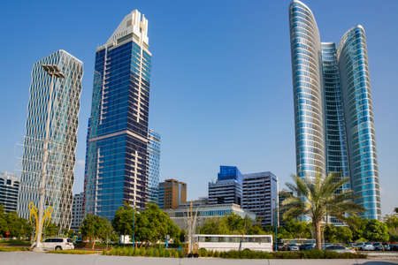 UAE, ABU DHABI, NOVEMBER, 2021 - Skyscrapers surrounded by a green park of palm trees near the La Corniche promenade in Abu Dhabi, capital of the United Arab Emirates.のeditorial素材