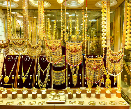 Golden jewelry at the gold street Deira market, also called Gold souk, in the city of Dubai, United Arab Emiratesの写真素材