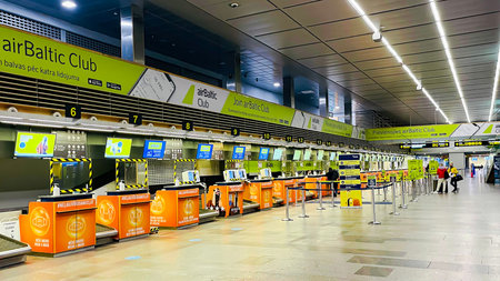LATVIA, RIGA, DECEMBER, 2021 - Check-in desks at AirBaltic company at the modern airport of Riga,...