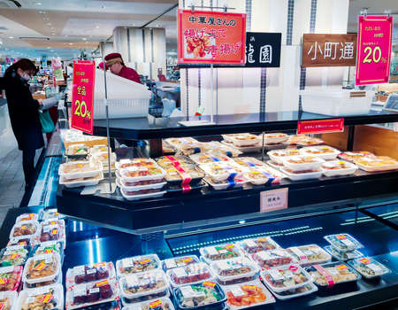 JAPAN, TOKYO, APRIL, 2017 - Freshly prepared food products and various snacks packed in plastic containers on display in large department store food hall in Tokyo, Japanのeditorial素材