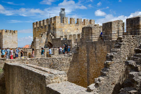 Sao Jorge castle or St. George castle with visitors in the old district of Alfama at Lisbon city, Portugal.のeditorial素材