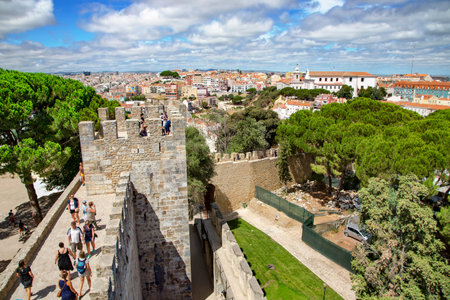 Sao Jorge castle or St. George castle with visitors in the old district of Alfama at Lisbon city, Portugal.のeditorial素材