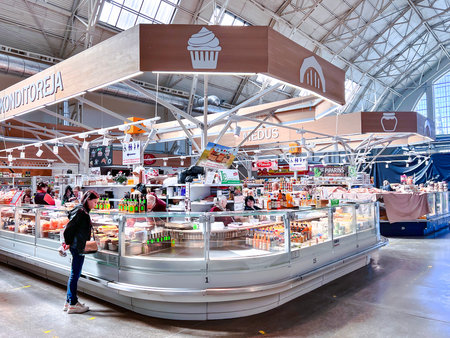 LATVIA, RIGA, APRIL, 2022 - Central market pavilion with trade gastronomic and confectionery counters in Riga, Latvia. Former zeppelin hangars.