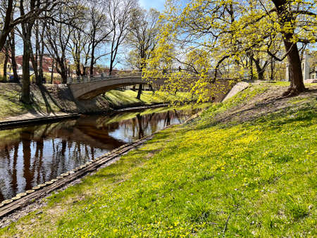 Stone bridge over Riga river canal in Bastion park early spring time at Riga, capital of Latviaの写真素材