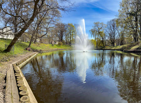 Panorama of the beautiful Riga canal with fountain near Bastion park in early spring day, Riga center, capital of Latvia.の写真素材