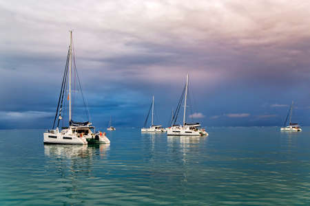 FRENCH POLYNESIA, PAPEETE, DECEMBER, 27, 2017 - Five catamarans at anchor off the island Papeete after the storm on Pacific ocean. Papeete, French Polynesiaのeditorial素材