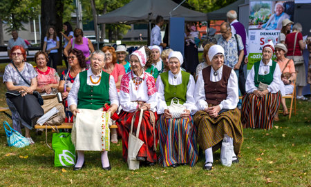 LATVIA, RIGA, AUGUST, 2022: Latvian women in national costumes at the city holiday for seniors in Riga, Latvia. Important event in Latvian culture and social life.のeditorial素材