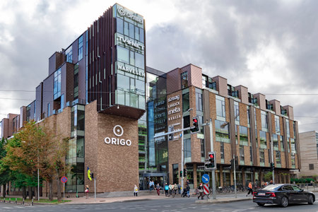LATVIA, RIGA, AUGUST, 2022 - Modern multi-storey Origo shopping center and road with cars that are located in the city center of Riga, capital of Latviaのeditorial素材