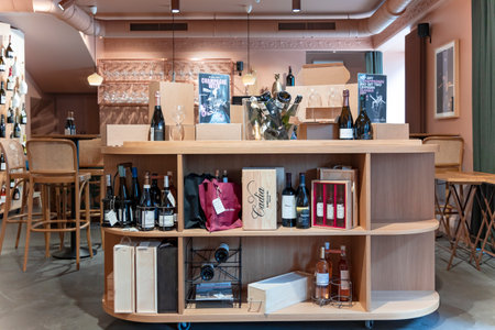 LATVIA, RIGA, AUGUST, 2022: Interior of modern wine boutique store with vintage style wooden showcases  in Riga, Latviaのeditorial素材