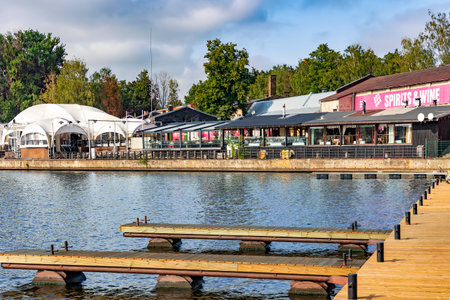 LATVIA, RIGA, AUGUST, 2022: Various summer cafes and wooden piers in Andrejosta quarter on the banks of the Daugava river in Riga, Latviaのeditorial素材