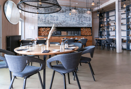 LATVIA, RIGA, AUGUST, 2022: Stylish modern interior Aqua Luna restaurant with fireplace in Andrejosta quarter on the banks of the Daugava river in Riga, Latvia in Riga, capital ofのeditorial素材