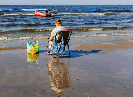 LATVIA, JURMALA, AUGUST, 2022 - People enjoying relaxing on the Baltic sea beach in Jurmala, Latvia.のeditorial素材
