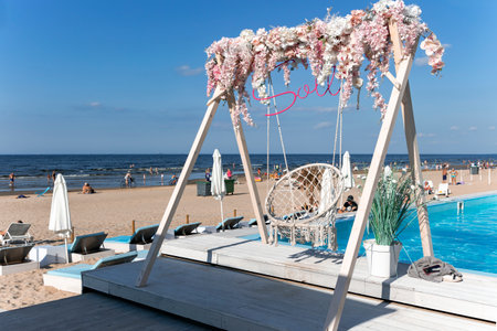 LATVIA, JURMALA, AUGUST, 2022 - People enjoying relaxing on the Baltic sea beach in Jurmala, Latvia. Healthy and sport lifestyle and activity in Jurmala.のeditorial素材