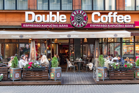 LATVIA, RIGA, SEPTEMBER, 2021 - People have lunch on the open-air veranda of Double Coffee cafe in Riga, Latvia.のeditorial素材