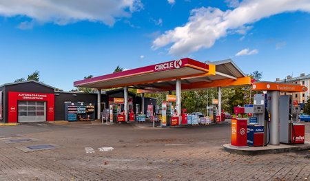 LATVIA, RIGA, OCTOBER, 2022: Urban infrastructure with a CIRCLE K petrol station with car wash surrounded by greenery, showing a well maintained environment in Riga, Latviaのeditorial素材